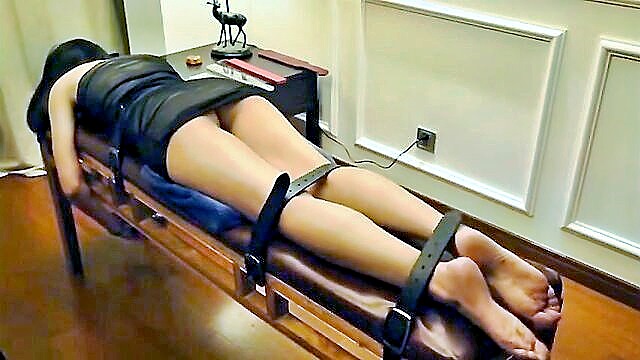 Chinese beauty bound in seductive bondage, teasing with tantalizing moves and craving your attention.