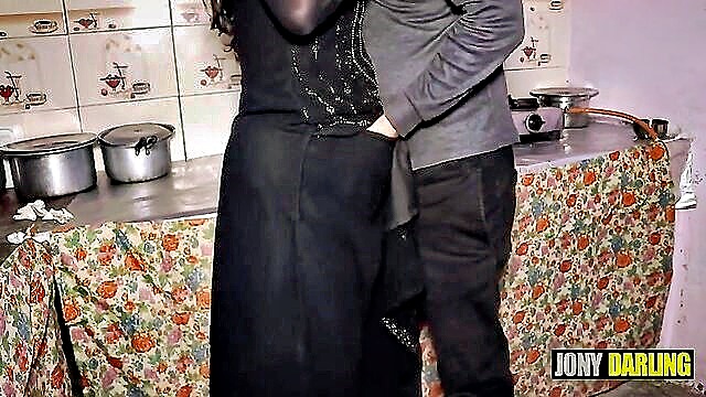 Sensual Indian aunty engages in kitchen passion with a young man in stunning high definition audio.