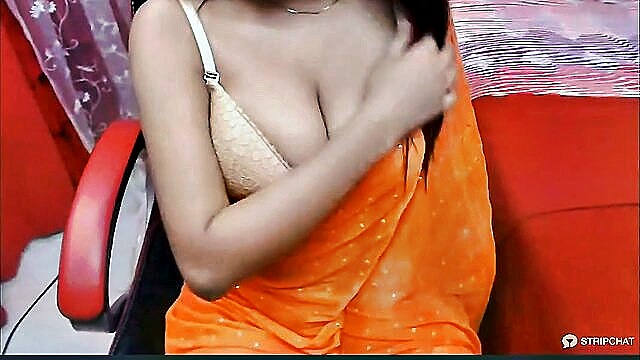 In this image, Indian beauty Lisa teases with a private striptease and indulges in self-pleasure, showcasing her tight pussy and big tits on a steamy webcam show at www.xxx.