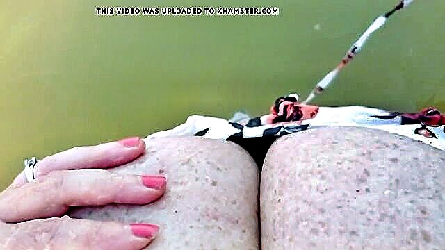 Serbian MILF Manuela Kurva reveling in water sports, her voluptuous curves accentuated in a bikini, indulging in self-pleasure.