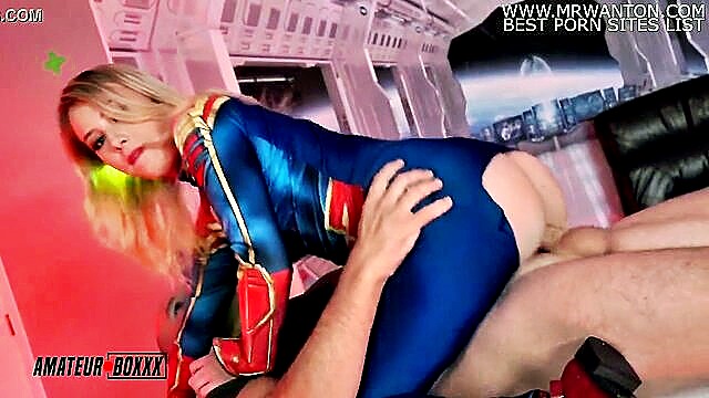 Dixie Lynn, a teen amateur boxer, cosplays as Captain Marvel in a wild sex adventure. She rides Sean Lawless in reverse cowgirl and cowgirl positions, leading to a messy finish.