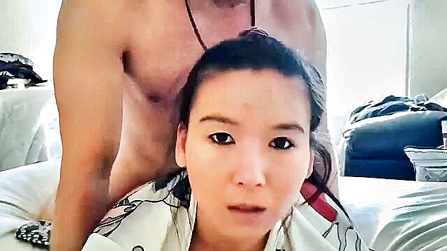 A young Asian girl engages in intense sexual activity in a homemade video, culminating in a messy cumshot.