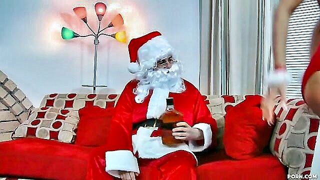 Seductive brunette Isis Love joins Santa for a steamy Christmas group sex session, igniting a wild holiday encounter.